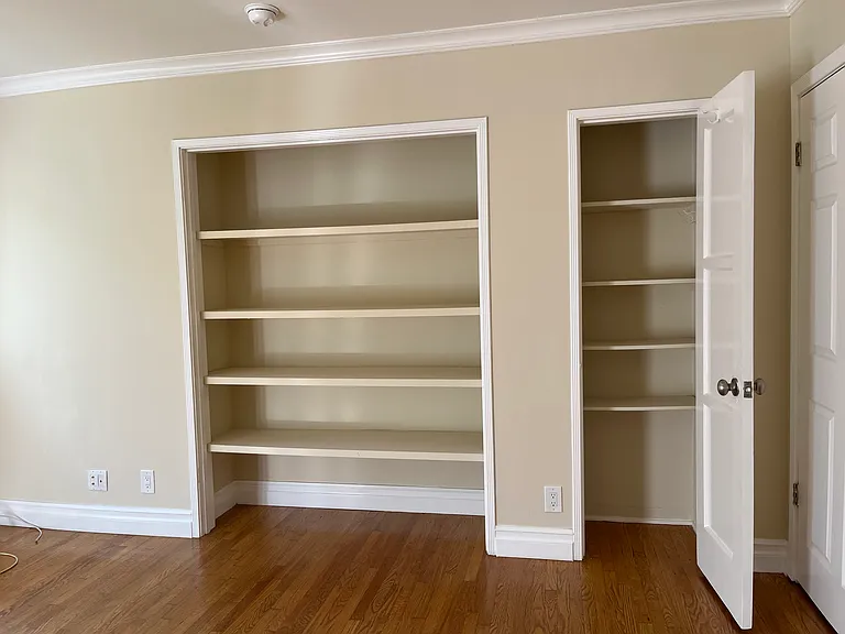 MAIN ROOM W/ BOOKSHELVES & LINEN CLOSET