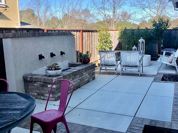 Professionally hardscaped backyard with large water feature.