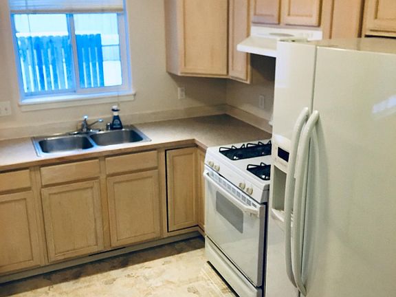 Light, bright, open kitchen with a gas range stove