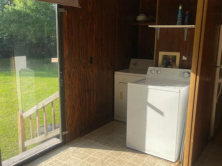 Off of kitchen and dining room is laundry area