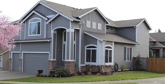 Sitting pretty on a large corner lot with fenced rear yard and 3 car garage.