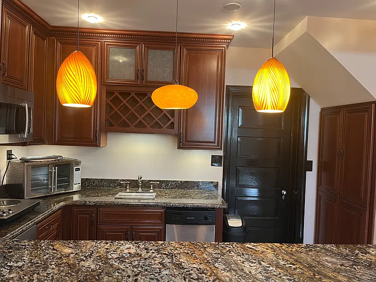 Exotic-grade, wrap-around granite countertops. Pendant lights and ceiling pin lights. Stainless steel dishwasher, sink (with garbage disposal) Two-burner cooktop and XL convection oven