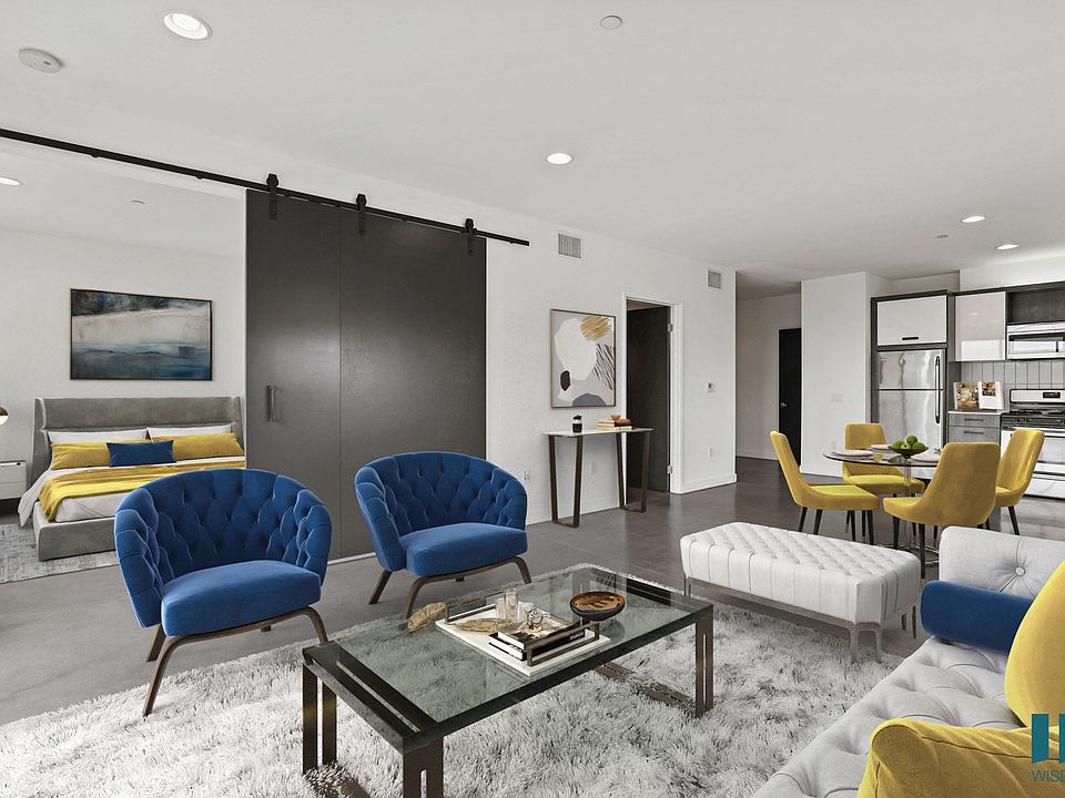 Open-Concept Kitchen, Dining, and Living Room Space with Enclosed Bedroom
