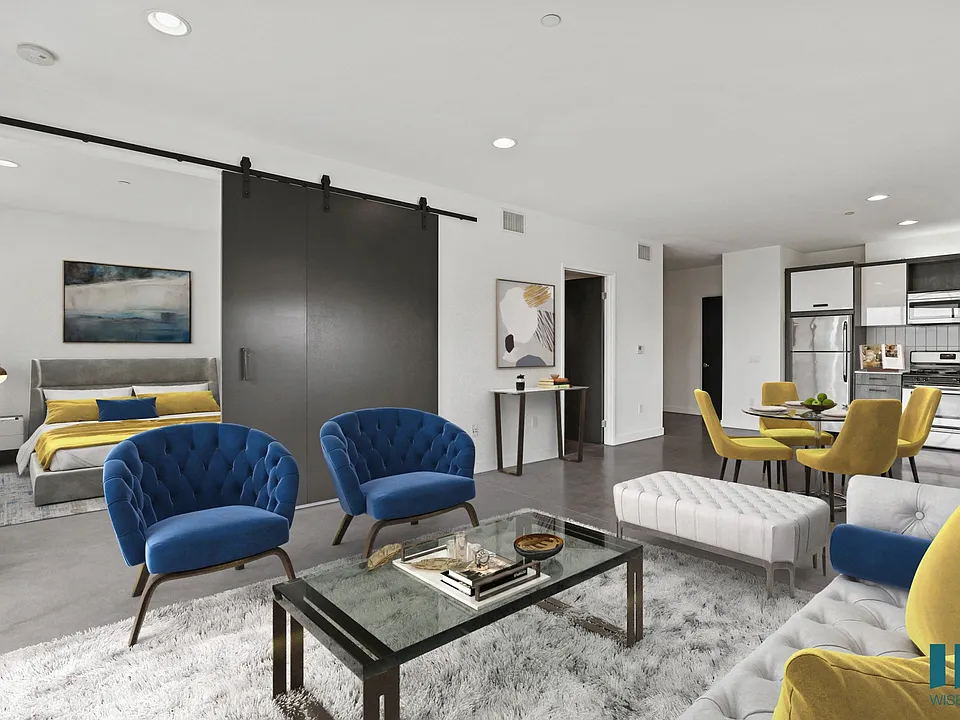 Open-Concept Kitchen, Dining, and Living Room Space with Enclosed Bedroom
