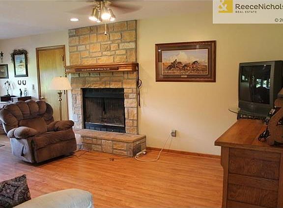 Laminate flooring, stone fireplace and open floor plan.