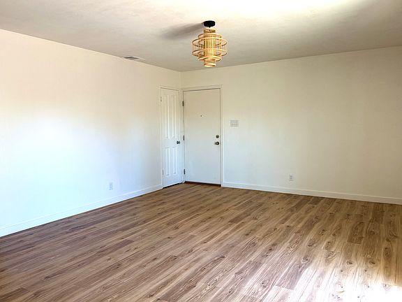 View from the kitchen, looking at the front door and entryway closet