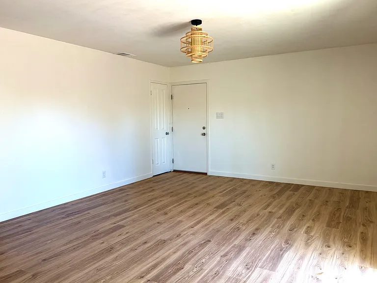 View from the kitchen, looking at the front door and entryway closet