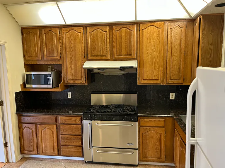 Granite countertop and wide stove/oven.