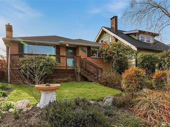 Beautiful brick home with low maintenance gardens.  One block from Camp Long.