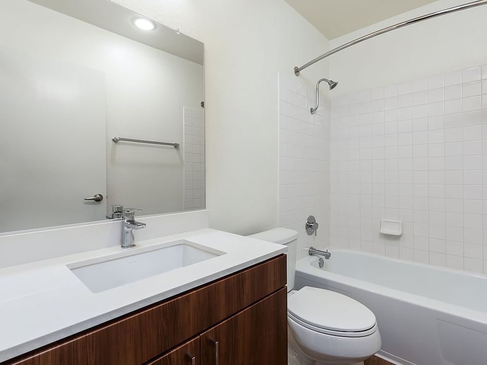 Renovated I bath with new cabinetry, quartz countertop, and hard surface flooring