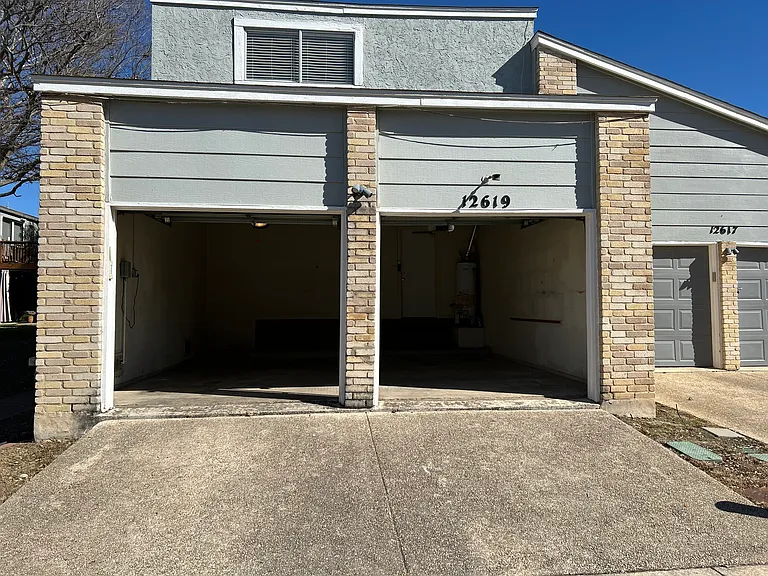 Oversized 2 car garage with garage door openers and remote controls.