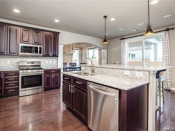 Gorgeous open concept kitchen with stainless appliances and beautiful granite
