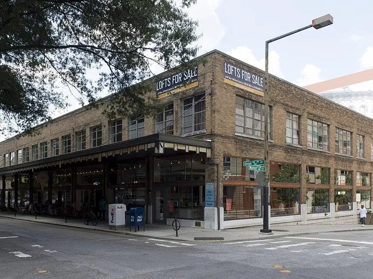 Unit 209 is the second floor corner showing two walls of floor-to-ceiling windows