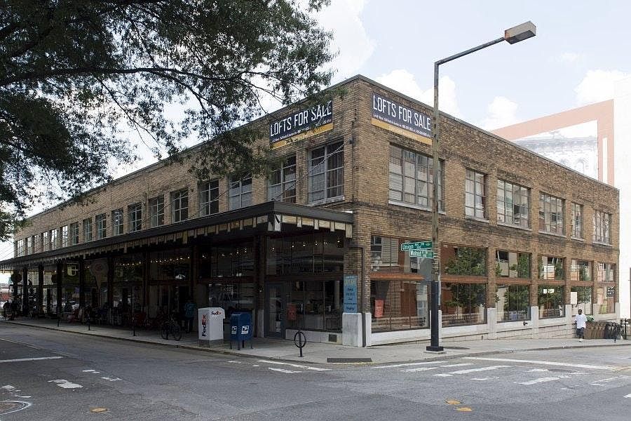 Unit 209 is the second floor corner showing two walls of floor-to-ceiling windows