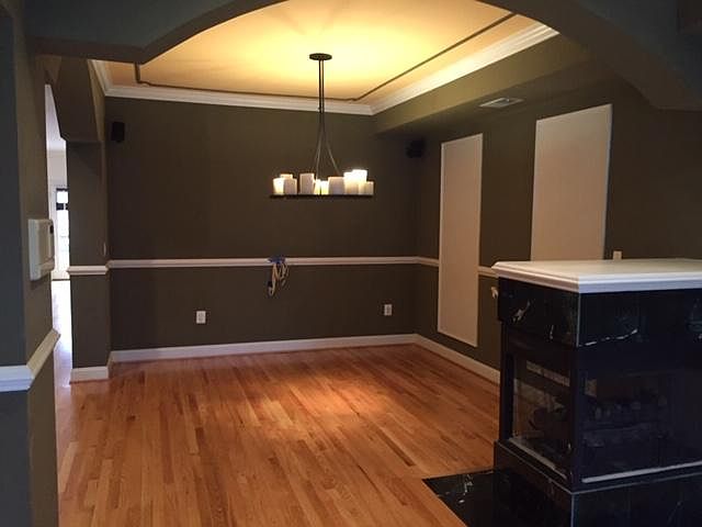 dining room with fireplace and Holly Hunt light fixture