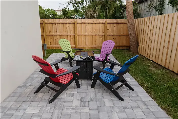 Cozy fire table surrounded by Adirondack chairs, perfect for evening gatherings under the stars.