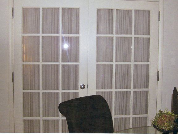 French Doors lead to bedroom, create an open floor plan