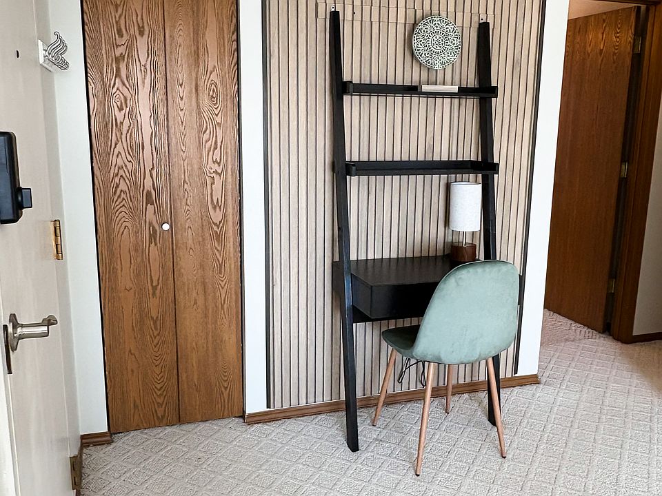 Small office space near front entryway and hall closet.