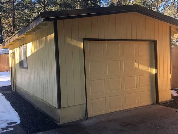 Single car garage, paved driveway.