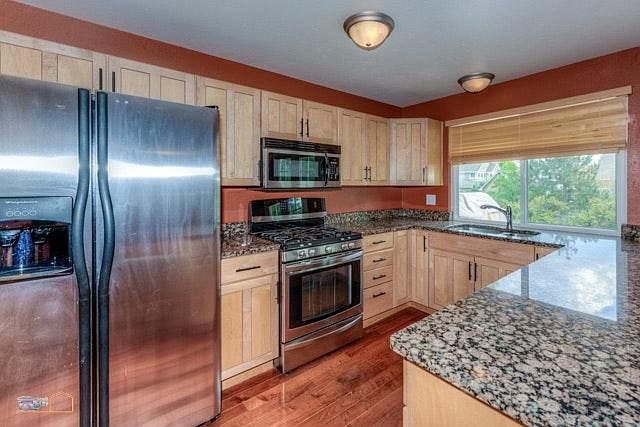 Remodeled kitchen with large granite peninsula
