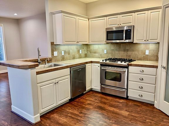 Kitchen with tile countertops and stainless appliances