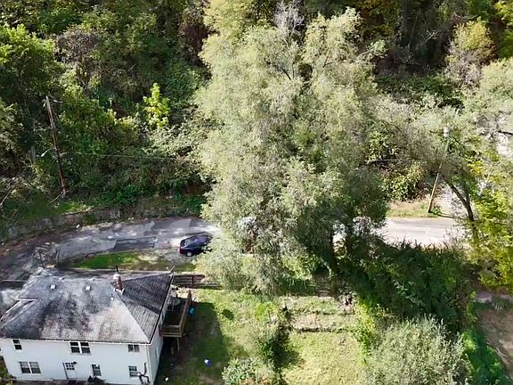 Bird eyes view of rear of home and street leading around home