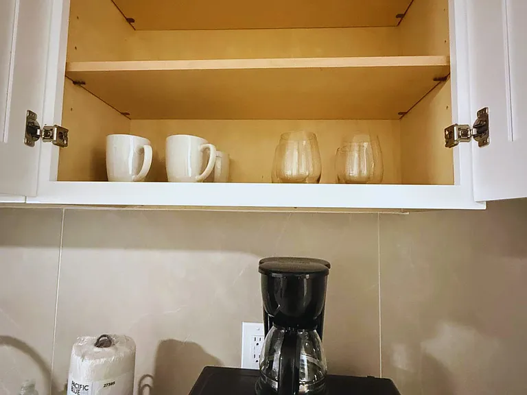 Crystal glasses and coffee mugs provided for your convenience.