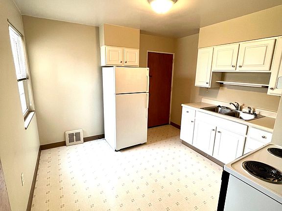 Kitchen with large window and eating area.