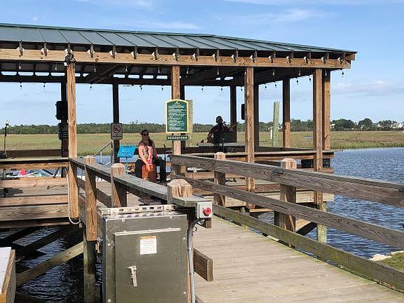 Dock used for fishing, boats, concerts overlooking pool