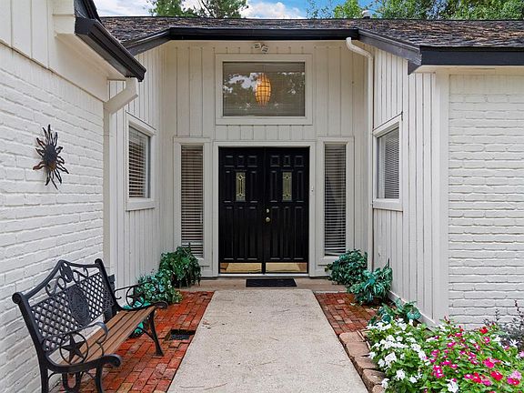 Gorgeous appeal with the bench at the front entry of the home, nice landscaping and beautiful double wood and glass insert doors.