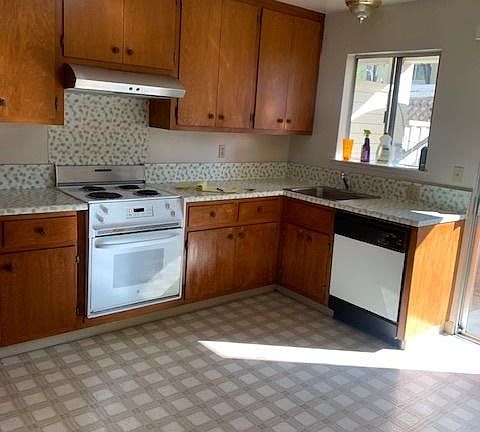 large kitchen lots of light and a dishwasher.