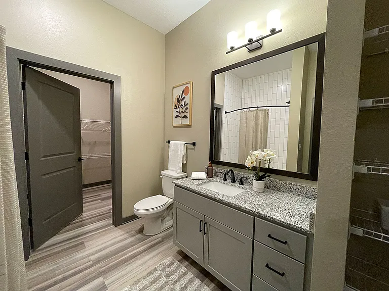 Experience the elegance of this contemporary bathroom, designed with sleek finishes and ample storage.