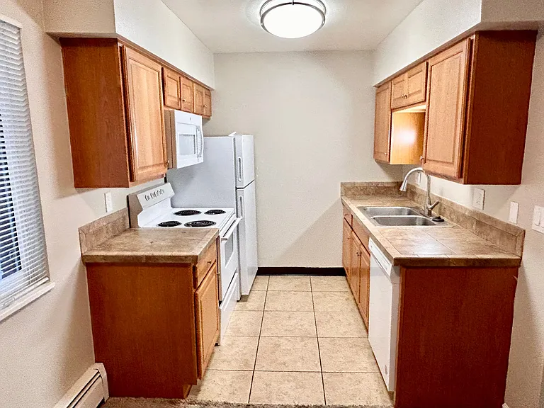 Experience the warmth of this functional apartment kitchen, perfect for home-cooked meals. Experience the warmth of this functional apartment kitchen, perfect for home-cooked meals.