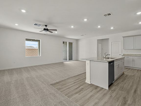 The family room is spacious with a ceiling fan.