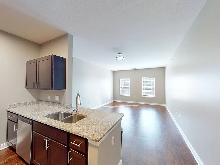 Start in the kitchen, stay for the view. This open layout flows into a sunlit living space that feels as good as it looks.