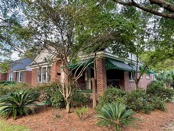 The corner porch is significantly elevated from the street - perfect for watching your friendly neighbors go by.