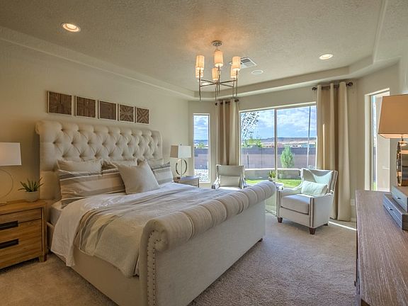 Master bedroom with bay window and tray ceiling creates a cozy space you ll never want to get out of