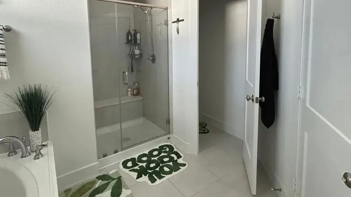Bathroom features a glass-enclosed shower, tile flooring, and a vanity with ample counter space and storage. - Starfish Arbor Dr
