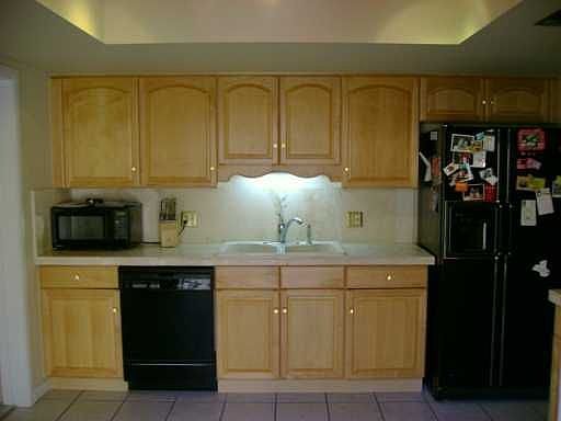 Kitchen has New Maple Cabinetry and Tiled Countertops.  New Appliances
