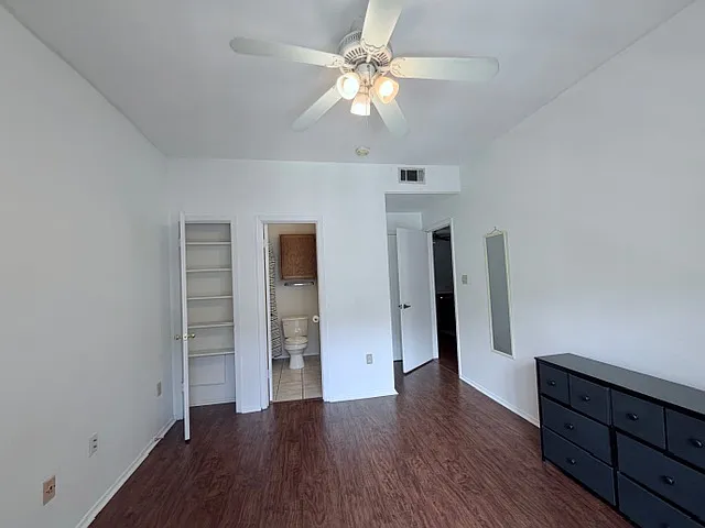 The spacious 1st bedroom walks into it's private bathroom and the walk-in closet on the right.