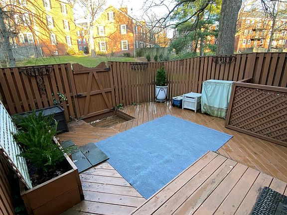 Private yard fully decked and open to a larger green area