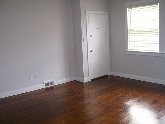 Living room has two large windows overlooking the court yard.