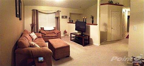 Spacious upstairs living space is light and airy. Features include hall coat closet, cathedral ceiling, multi-panel doors, and plant shelves.