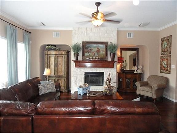 The family room is open to the kitchen and also has hardwood flooring and upgraded ceiling fans. Also has surround sound.