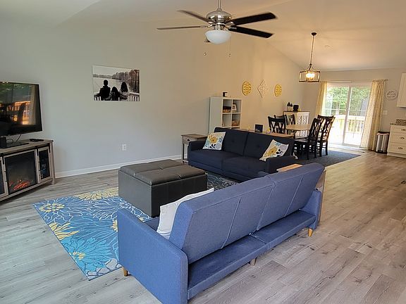 Open concept living/dining/kitchen area with walk out to deck and backyard