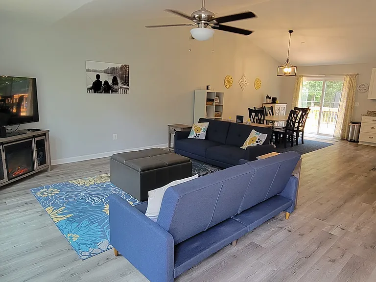 Open concept living/dining/kitchen area with walk out to deck and backyard
