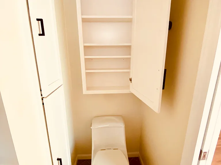 The bathroom has plenty storage space.