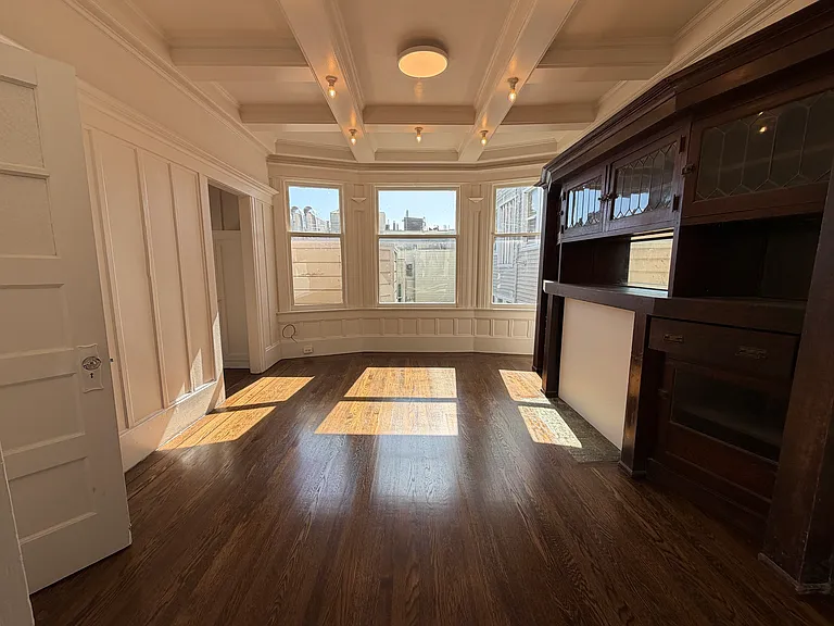 Dining room with built in vintage cabinet/storage. Access to kitchen is on top right of photo.
