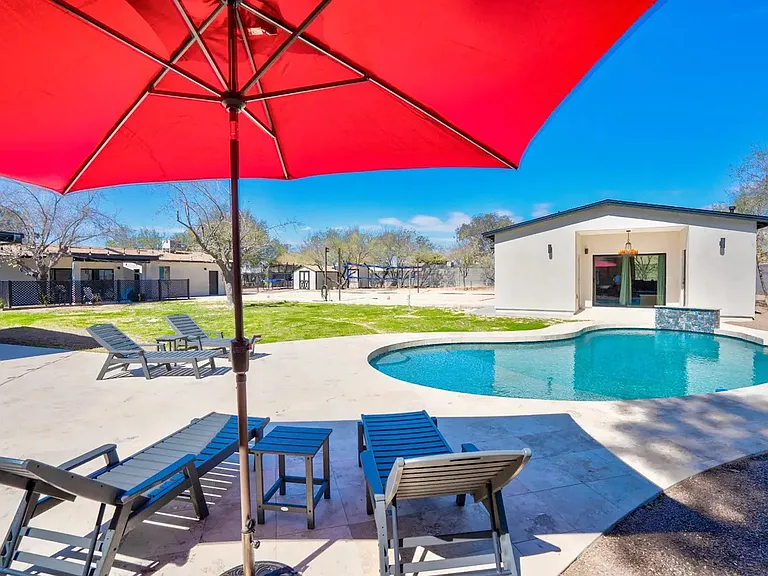 Back yard: pool, casita, grass play area, sand volleyball.
