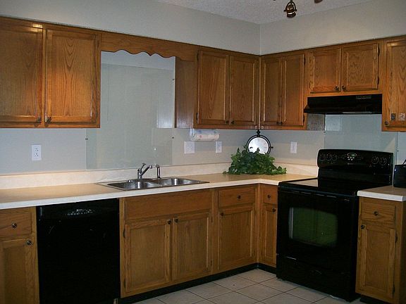 Kitchen has plenty of space and black Maytag appliances.